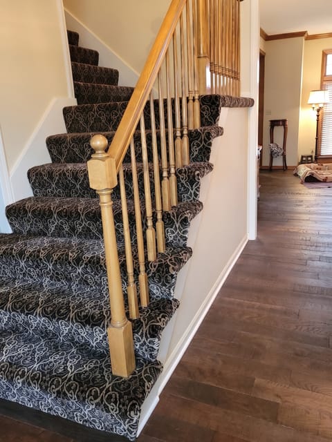 Hardwood staircase with a patterned runner