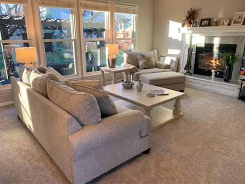 Living room with wall-to-wall carpet flooring and a fireplace